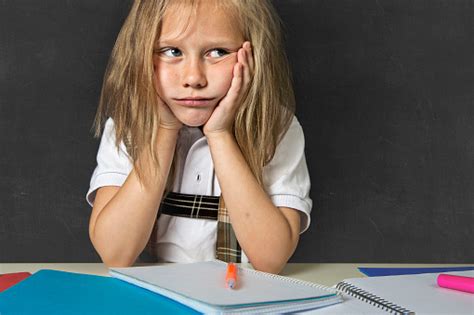 Tired Cute Blond Schoolgirl In Stress Working Homework Bored