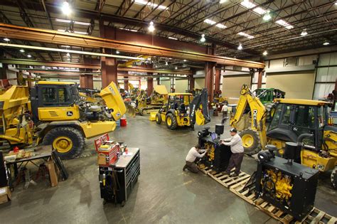 workers  working  construction equipment   large warehouse  lots  machines
