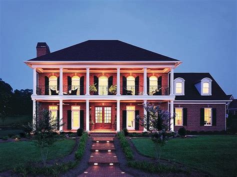 large house  columns  lights   front porch  night time