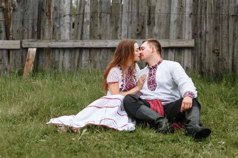 a couple in love in russian traditional dresses with medical masks on