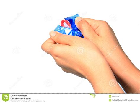 woman holding condom in hand hand holding a condom in