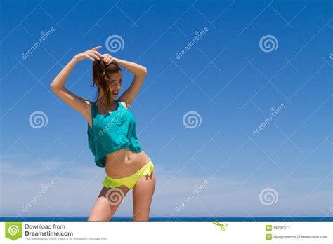 brunette teen in bikini and beachwear enjoys the stock image image of looking sensuous 56737311