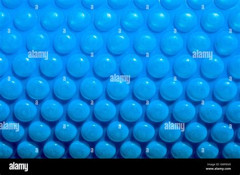 Abstract Closeup Of Bright Blue Bubble Pool Cover With Round Bumpy