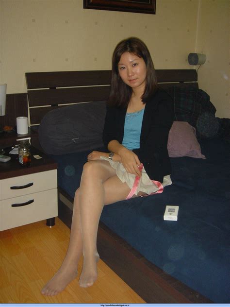 asian babe with legs crossed while wearing pantyhose and