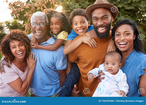 portrait  multi generation african american family relaxing  garden  home  stock