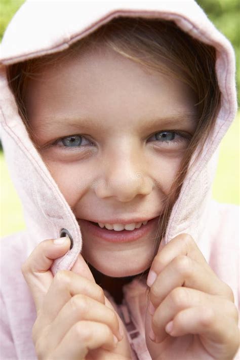 portrait  girl hiding face  pink hooded top stock photo image  camera head