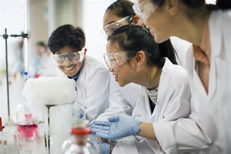 high school students conducting scientific experiment center