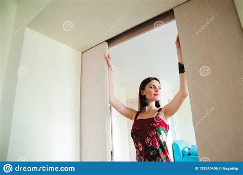 young woman opening door  modern hotel room stock photo image