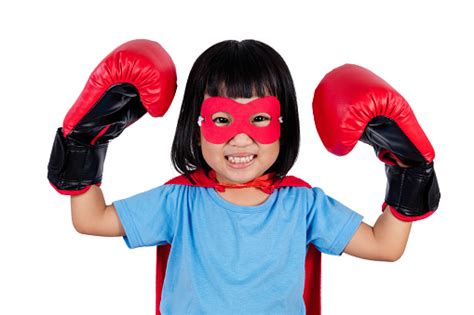 asian little chinese girl wearing super hero costume with boxing stock