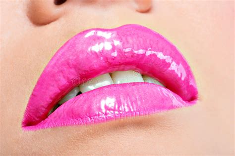 closeup beautiful female lips with pink lipstick stock