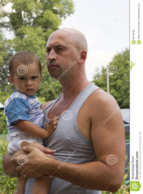 dad with a small son in his arms against the wall on the