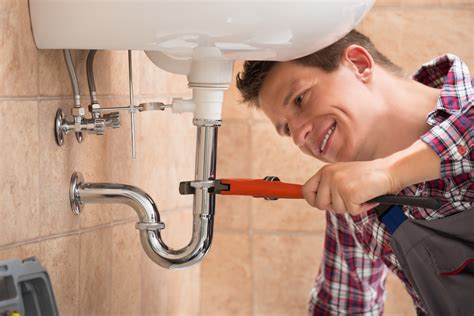 plumber fixing sink pipe  adjustable wrench certified leak