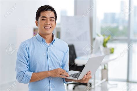 man holding  laptop computer   office stock photo