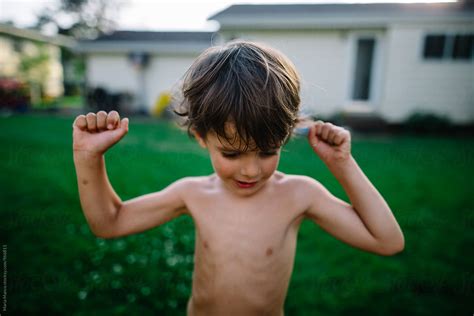 boy flexes  muscles del colaborador de stocksy maria manco stocksy