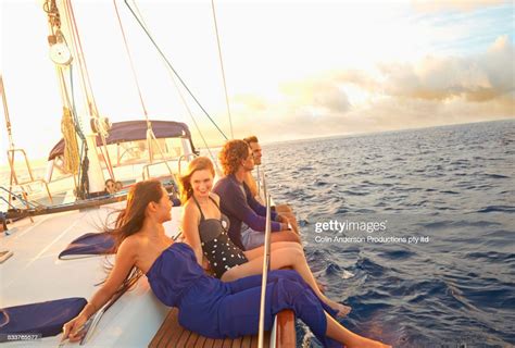 Friends Dangling Legs Over Yacht Deck Photo Getty Images