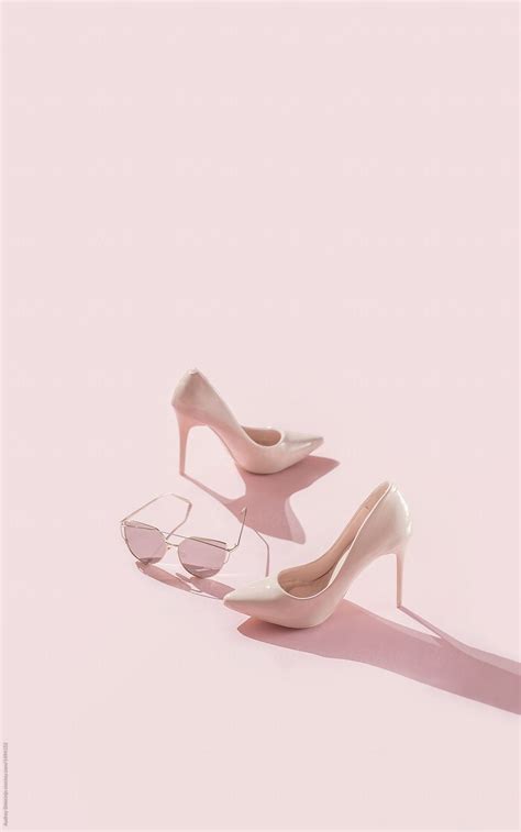 pink female high heels shoes on pink background by audrey shtecinjo