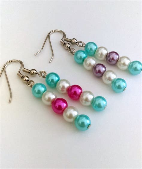 pairs  colorful pearls  hanging  silver hooks   white