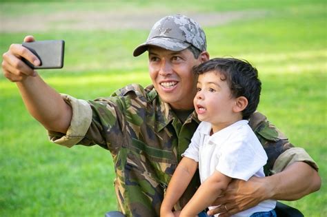 free photo cheerful disabled military dad and his little