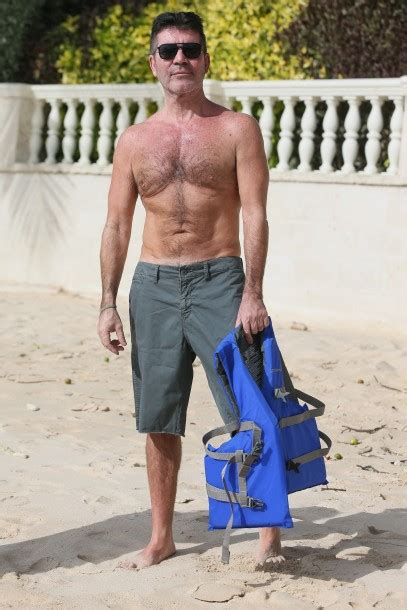 simon cowell spotted with black eye and fit physique while on vacation