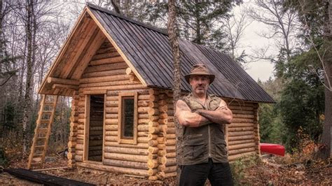 man builds  grid log cabin  canadian wilderness  hand tools