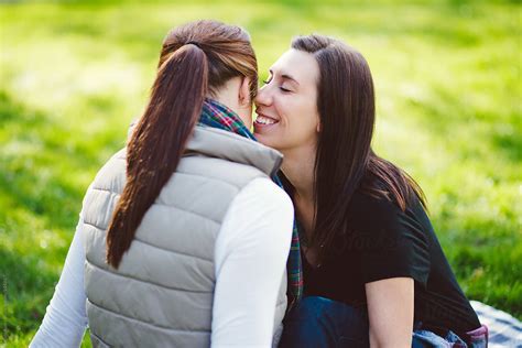 Lesbian Couple Sitting On Blanket In The Park By Stocksy Contributor