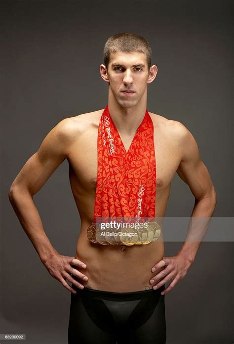 swimmer michael phelps of the united states poses with his eight gold