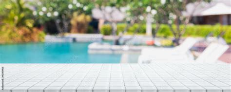 plakat empty white ceramic mosaic table top  blurred swimming pool