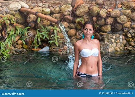 Tanned Beautiful Girl Taking Baths In Hot Springs In White Bikini