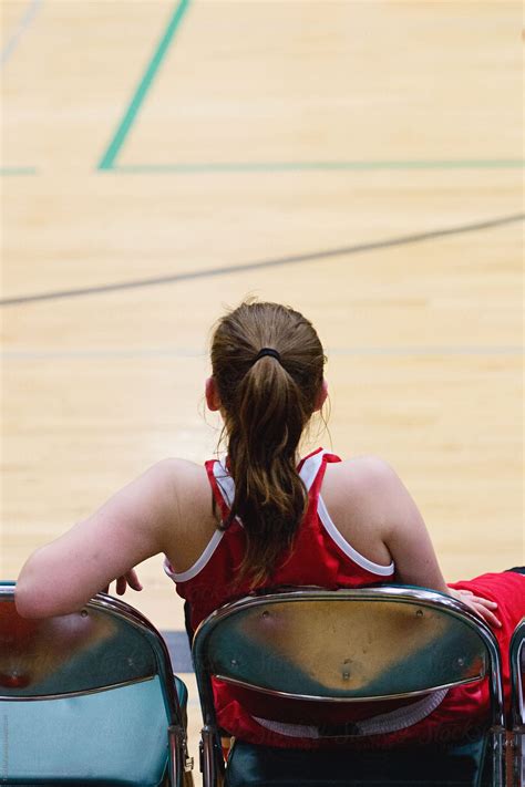 female basketball player sits in chair watching game del colaborador