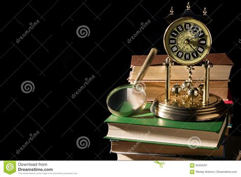 Literature Concept Magnifying Glass Near Vintage Clock On