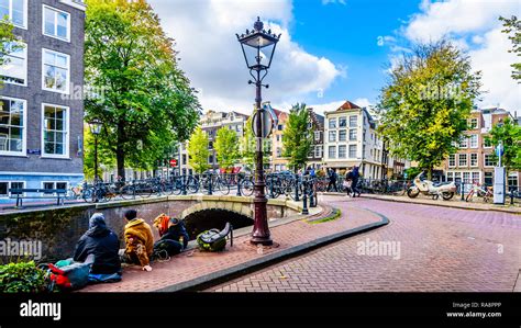 tourists hanging    bridge  blauwburgwal canal   junction   herengracht