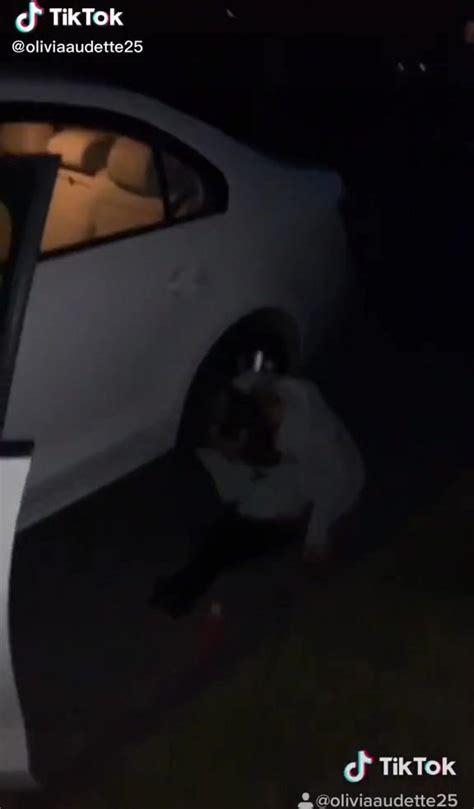 girl peeing next to a car on the road