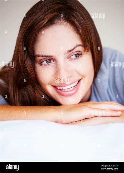 Smiling Cute Female Brunette Lying On Bed Closeup Portrait Of A Cute