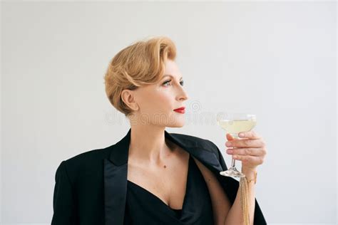 Mature Stylish Elegant Woman In Tuxedo With Glass Of Sparkling Wine