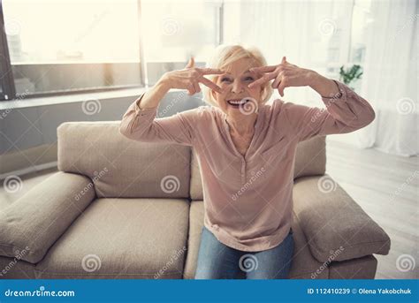 Optimistic Granny Sitting On Sofa Indoors Stock Image Image Of Casual