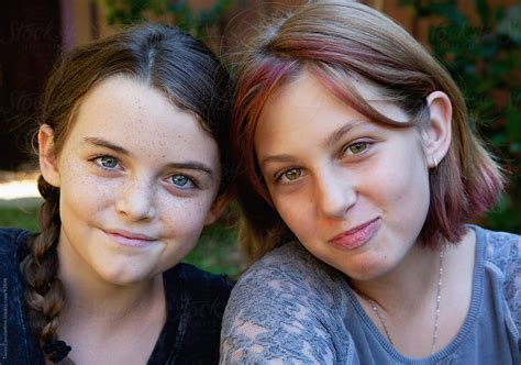 close up of two smiling tween girl friends by stocksy contributor