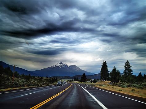 highway road   mountains  heavy clouds image  stock