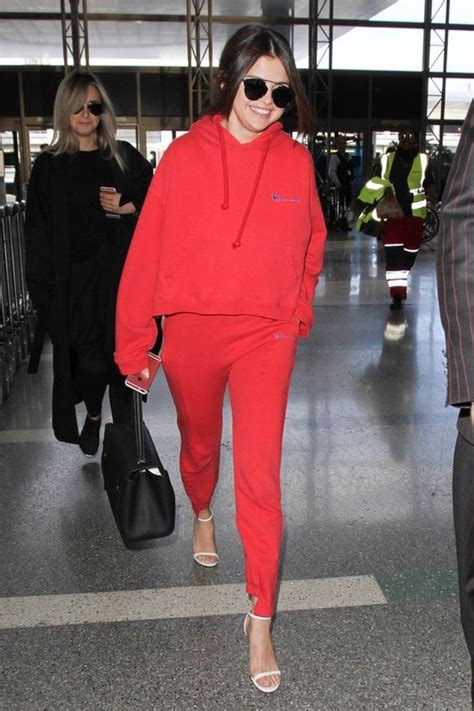 selena gomez paired a red hoodie with matching sweats adding heels for a chic twist hoodie