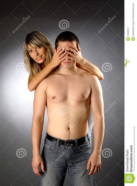 Beautiful Girls Covers Eyes Of Half Naked Man Stock Image
