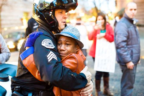 photo police officer  young demonstrator share hug  ferguson