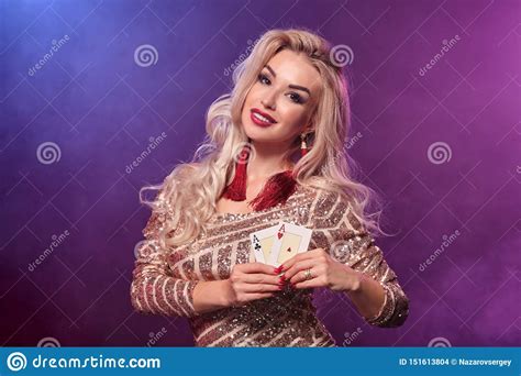 blonde woman with a perfect hairstyle and bright make up is posing with