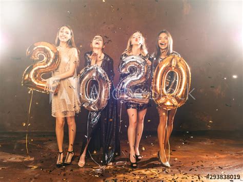 beautiful women celebrating new year happy gorgeous girls in stylish sexy party dresses holding