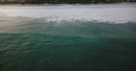 drone camera  huge blue ocean foamy wave rushing  beautiful exotic resort shore