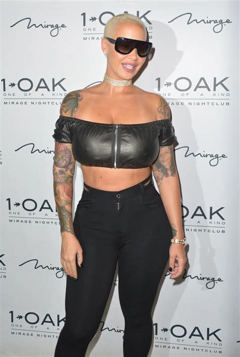 body party amber rose smirks in boob baring leather crop