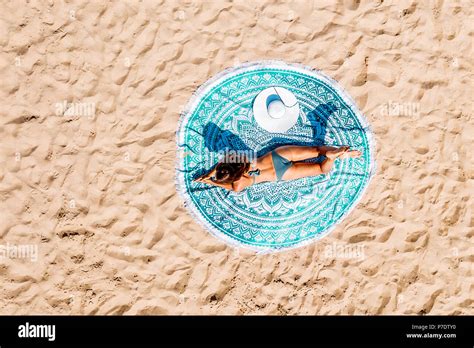 top aerial drone view  woman  swimsuit bikini relaxing  sunbathing   turquoise
