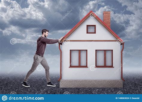 side view  young handsome man  casual clothes pushing  storeyed detached house  gravel