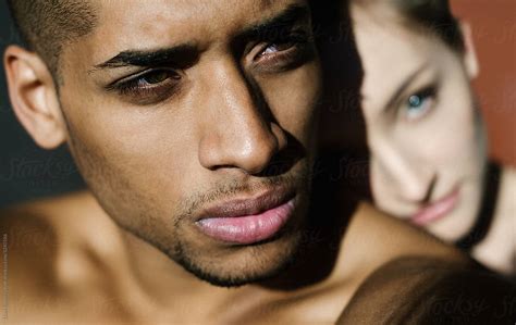 Portrait Of Black Man With White Girl On The Background By Stocksy