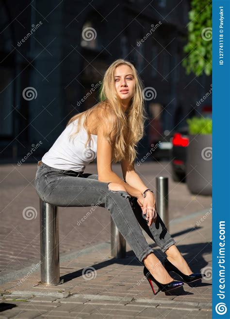 Seductive Blonde Model With Long Hair Wearing Jeans And T Shirt Stock