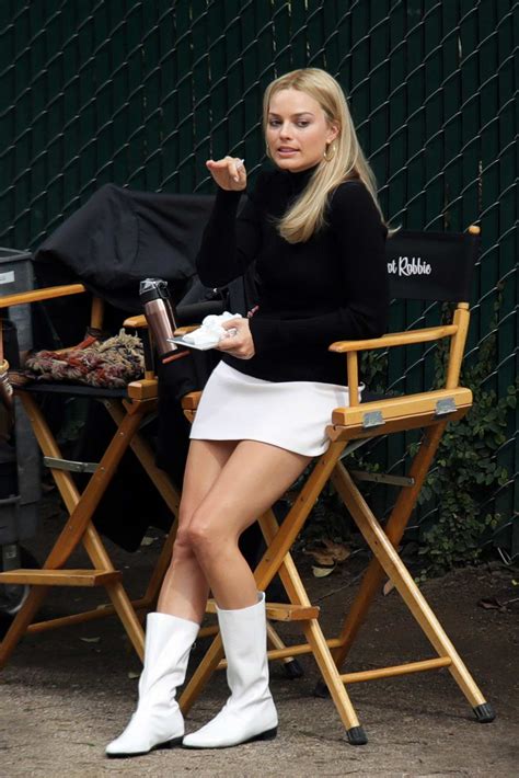 Margot Robbie Spotted In A White Short Skirt And Black Turtleneck While
