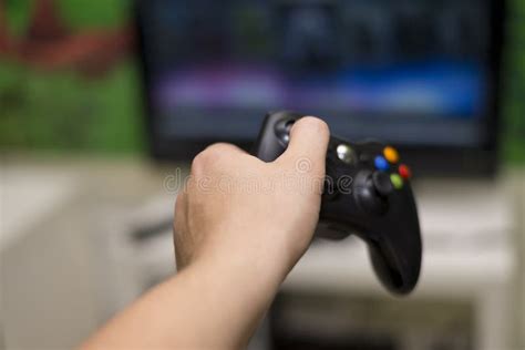 mans hand holding  joystick  play  front   tv stock photo